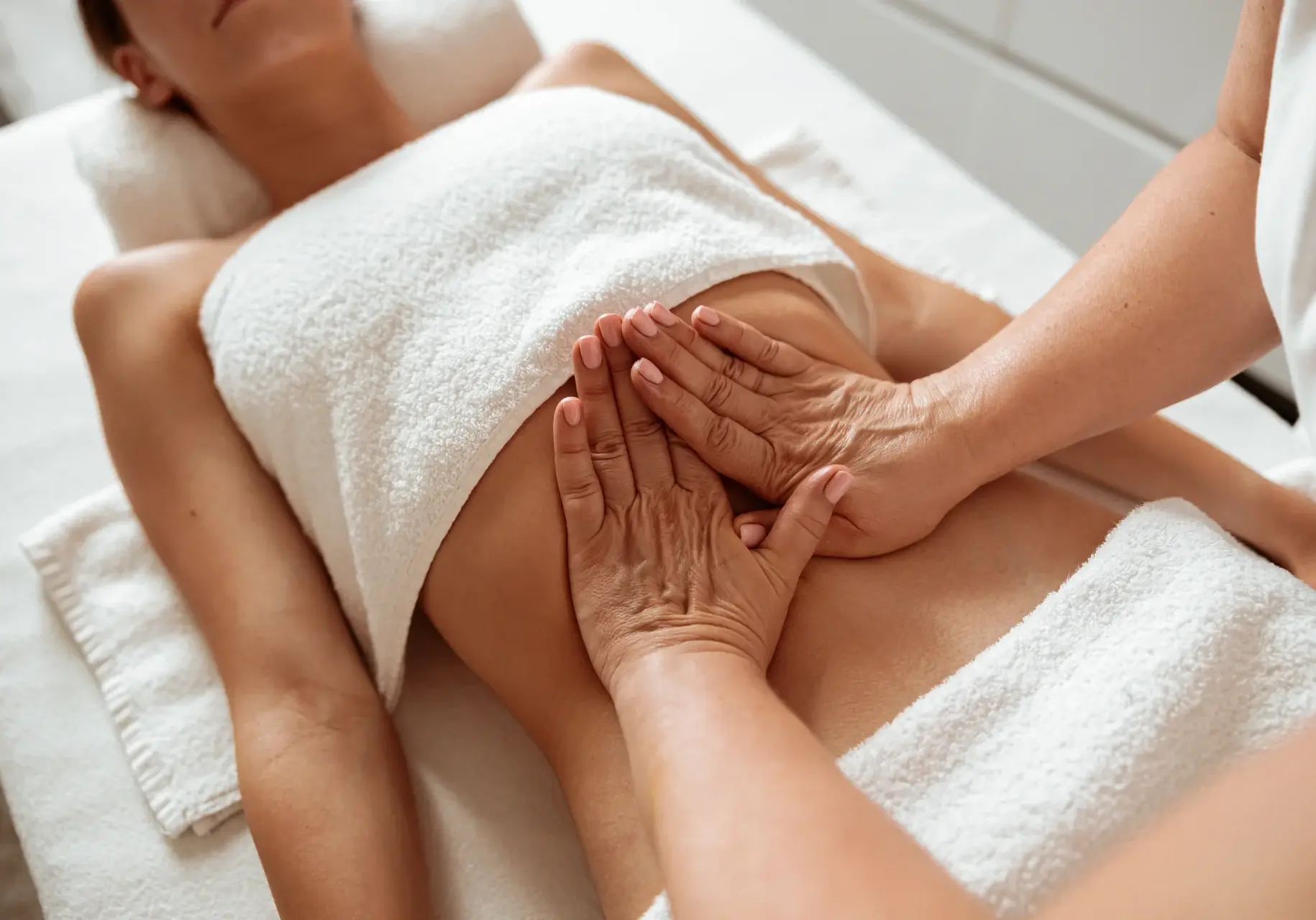 masseuse-hands-massaging-female-client-abdomen-in-2025-03-14-16-54-52-utc